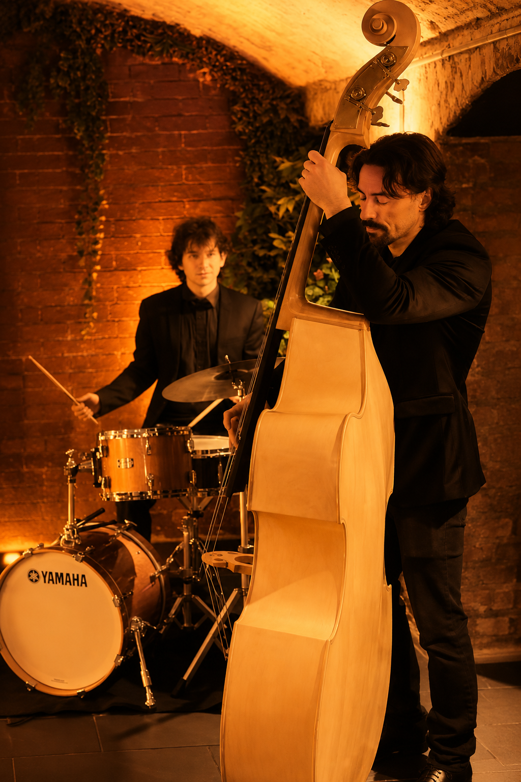 Double bass and drums in a brick-walled venue